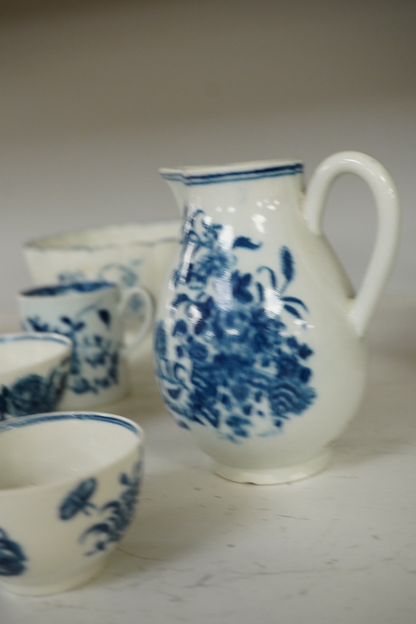 A collection of first period Worcester blue and white porcelain to include a Fence pattern sparrow-beak jug, a fluted Gilly-flower pattern bowl, a peony rock bird scallop shell pickle dish, a butter boat, a fisherman and